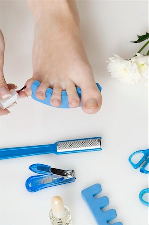 putting red varnish on foot nails with acessory in background Stock Photo - Budget Royalty-Free & Subscription, Code: 400-05069015