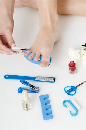 putting red varnish on foot nails with acessory in background Stock Photo - Budget Royalty-Free & Subscription, Code: 400-05069016