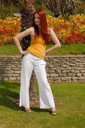 Cute girl  in yellow top and white pants in beautiful gardens Photographie de stock - Aubaine LD & Abonnement, Code: 400-05069348