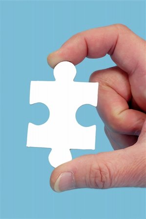 simsearch:640-01355058,k - Hand and puzzle, isolated on blue background Photographie de stock - Aubaine LD & Abonnement, Code: 400-05069368