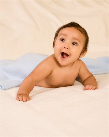 Surprised infant lying down on his tummy on blanket with open mouth Stock Photo - Budget Royalty-Free & Subscription, Code: 400-05069601