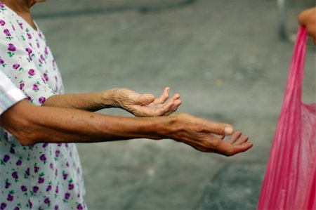 Hands of some street beggars beg for food and arms. Stock Photo - Budget Royalty-Free & Subscription, Code: 400-05069717