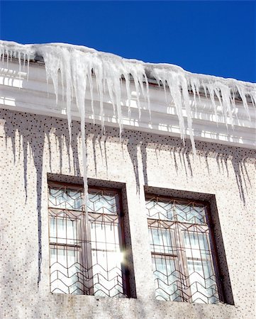 Two windows with reflection sun. On roof greater icicles. The Mood light, spring. Stock Photo - Budget Royalty-Free & Subscription, Code: 400-05060611