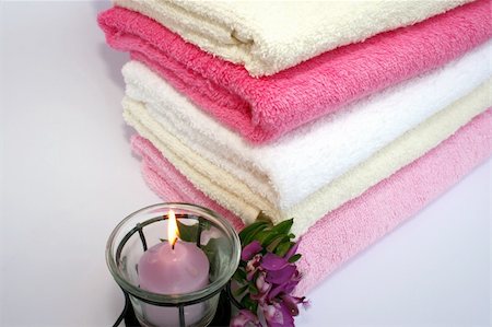 simsearch:400-04501066,k - Stack of clean colorful towels with candle and flowers close-up. Stock Photo - Budget Royalty-Free & Subscription, Code: 400-05060642