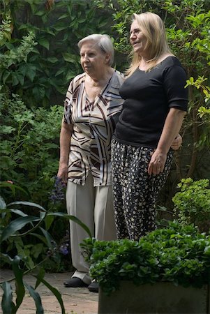 A shot of an adult child with her mother, walking in garden. Stock Photo - Budget Royalty-Free & Subscription, Code: 400-05060806