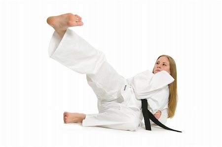 female foot kicks - Black belt female martial artist doing kick on the ground. Stock Photo - Budget Royalty-Free & Subscription, Code: 400-05061074
