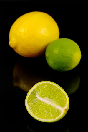 Lemon and lime citrus fruit isolated against a black background Stock Photo - Budget Royalty-Free & Subscription, Code: 400-05061411