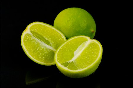 Lemon and lime citrus fruit isolated against a black background Stock Photo - Budget Royalty-Free & Subscription, Code: 400-05061412