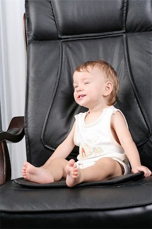 simsearch:400-04093413,k - Very important small kid sits on real boss leather chair Stock Photo - Budget Royalty-Free & Subscription, Code: 400-05062074