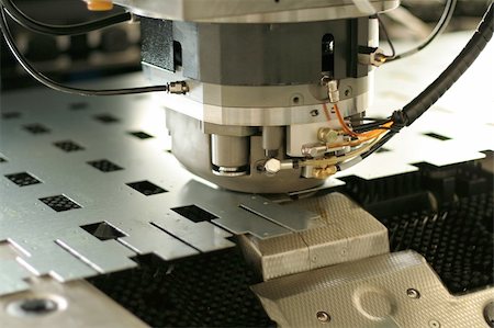 High precision CNC sheet metal stamping and punching machinery. Extreme close up Stockbilder - Microstock & Abonnement, Bildnummer: 400-05062078