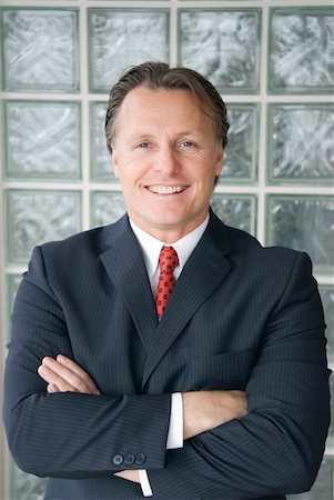 doctor lawyer - A handsome businessman with his arms folded lokks at the camera giving a beaming smile of confidence. Stock Photo - Budget Royalty-Free & Subscription, Code: 400-05062298