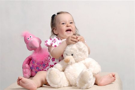flamingo not pink not bird - Laughing cute baby with teddy bear and rose flamingo isolated on white background Stock Photo - Budget Royalty-Free & Subscription, Code: 400-05074053