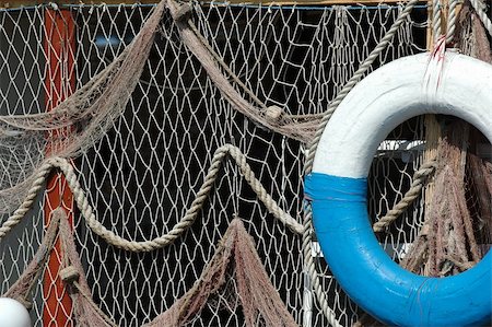 simsearch:400-05254289,k - Old net and old lifebuoy are hanging on land Photographie de stock - Aubaine LD & Abonnement, Code: 400-05074835