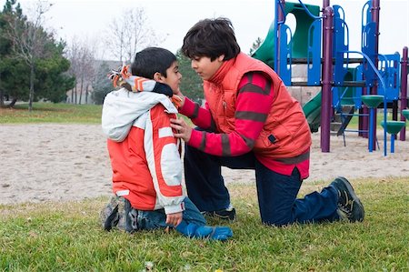 A boy checks on his younger brother at the park Stock Photo - Budget Royalty-Free & Subscription, Code: 400-05075401