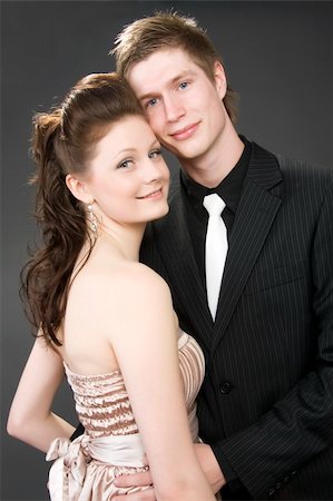 Portrait of a young beautiful couple embracing. (gray background) Stock Photo - Budget Royalty-Free & Subscription, Code: 400-05075418