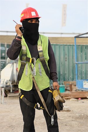 A Construction Worker Wearing Protective Gear & Using A Handheld Transceiver Stock Photo - Budget Royalty-Free & Subscription, Code: 400-05075845