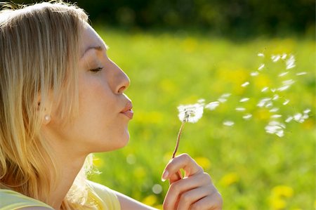 simsearch:400-04107729,k - The girl blows on a dandelion on a background of a grass Stock Photo - Budget Royalty-Free & Subscription, Code: 400-05076031