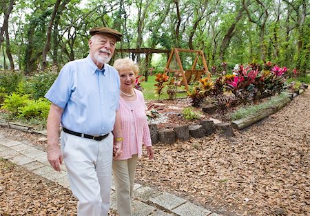 simsearch:400-05234340,k - Happy senior couple taking an afternoon stroll in the park. Stock Photo - Budget Royalty-Free & Subscription, Code: 400-05077317