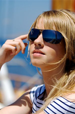 sailing fashion women - Beautiful young woman in sunglasses sailing on a boat Stock Photo - Budget Royalty-Free & Subscription, Code: 400-05077476