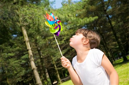 pictures of kids blowing a pinwheel - Young girl in park blowing on pinwheel. Stock Photo - Budget Royalty-Free & Subscription, Code: 400-05077575