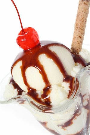 Delicious vanilla ice cream sundae topped with chocolate sauce, wafer and Maraschino cherry Stock Photo - Budget Royalty-Free & Subscription, Code: 400-05077593