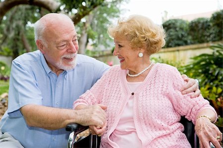 simsearch:400-04065020,k - Senior couple talking and laughing together outdoors.  She is in a wheelchair. Foto de stock - Royalty-Free Super Valor e Assinatura, Número: 400-05077665
