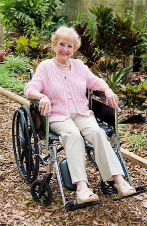 Beautiful senior lady smiling outdoors in her wheelchair.  Full body view Stock Photo - Budget Royalty-Free & Subscription, Code: 400-05077666