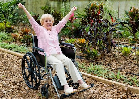 Beautiful senior lady in wheelchair is overjoyed because she has triumphed over her health problems. Stock Photo - Budget Royalty-Free & Subscription, Code: 400-05077670