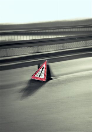 Danger sign on the road with motion effect Foto de stock - Super Valor sin royalties y Suscripción, Código: 400-05078239