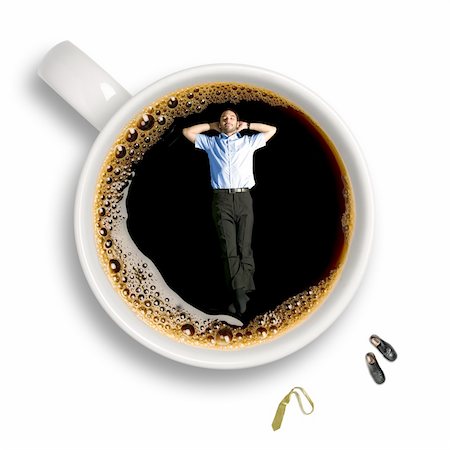 simsearch:400-05382322,k - Top view of a young business man taking a nap inside an isolated cup of coffee with his tie and shoes sitting aside. Stockbilder - Microstock & Abonnement, Bildnummer: 400-05078394