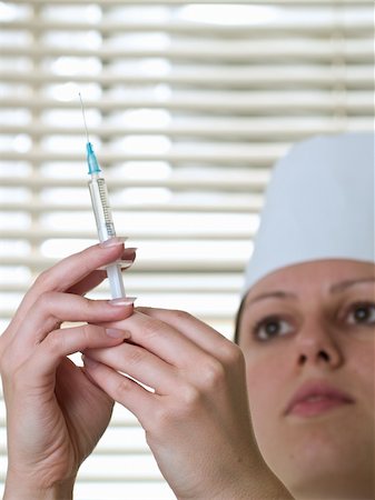 simsearch:400-05060422,k - Beautiful nurse with squirt ready to make injection Stock Photo - Budget Royalty-Free & Subscription, Code: 400-05078533