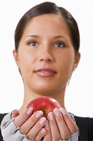 Girl offering a red apple.Selective focus on the apple. Stock Photo - Budget Royalty-Free & Subscription, Code: 400-05079351