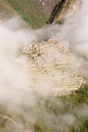 Machu Picchu  is a pre-Columbian Inca site located 2,400 meters (7,875 ft) above sea level. It is situated on a mountain ridge above the Urubamba Valley in Peru, which is 80 km (50 mi) northwest of Cusco. Often referred to as "The Lost City of the Incas", Machu Picchu is probably the most familiar symbol of the Inca Empire. Stock Photo - Budget Royalty-Free & Subscription, Code: 400-05079450