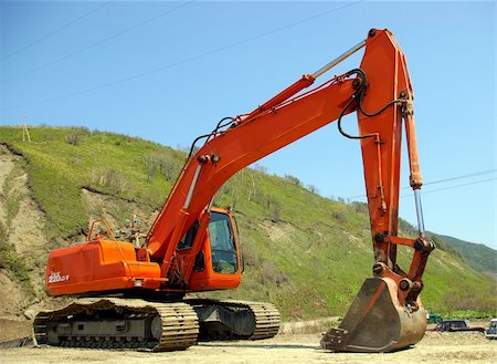 The Big caterpillar excavator of the orange colour after functioning. Stock Photo - Budget Royalty-Free & Subscription, Code: 400-05070002