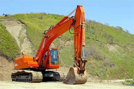 The Big caterpillar excavator of the orange colour after functioning. Stock Photo - Budget Royalty-Free & Subscription, Code: 400-05070003