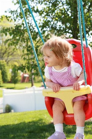 Happy Little Girl Swinging in Her Swing Stock Photo - Budget Royalty-Free & Subscription, Code: 400-05070761
