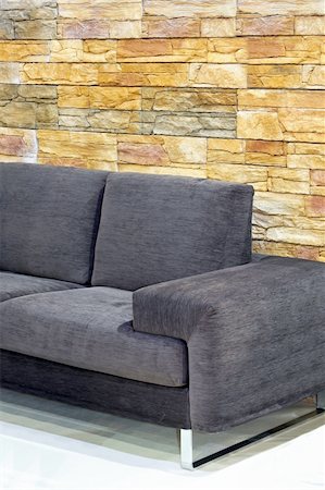 Grey sofa with wall made from sold stones Stock Photo - Budget Royalty-Free & Subscription, Code: 400-05070968