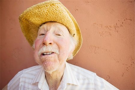 Senior Citizen Man with a Funny Expression Wearing a Straw Cowboy Hat Stock Photo - Budget Royalty-Free & Subscription, Code: 400-05071444