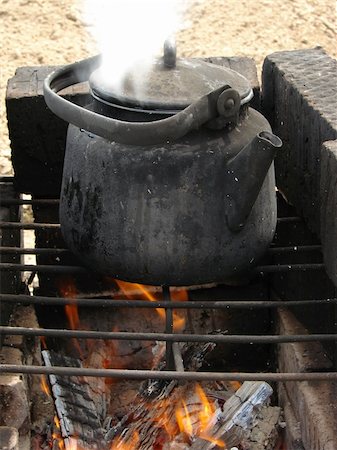 steaming kettles - boiling water in old sooty kettle on the hiking campfire Stock Photo - Budget Royalty-Free & Subscription, Code: 400-05071703