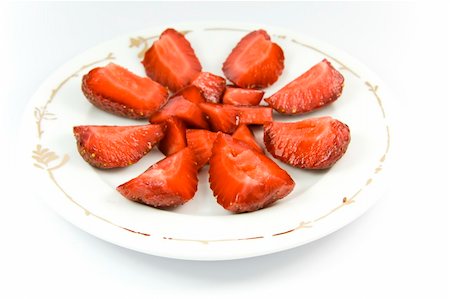 Sliced strawberries on plate over white Stock Photo - Budget Royalty-Free & Subscription, Code: 400-05072598