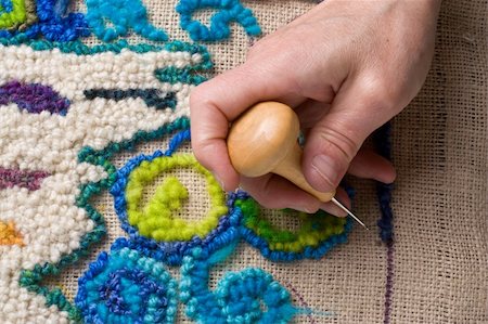 Hooking a rug, a traditional English craft that recyles old fabrics into vibrant mats using burlap. Stockbilder - Microstock & Abonnement, Bildnummer: 400-05072641