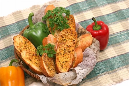 fine herb - Toasted garlic bread in a basket with capsicums and parsley laid on a checkered mat. Stock Photo - Budget Royalty-Free & Subscription, Code: 400-05072783