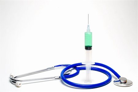 simsearch:400-04501269,k - A medical syringe surrounded by a stethoscope. Stock Photo - Budget Royalty-Free & Subscription, Code: 400-05072971