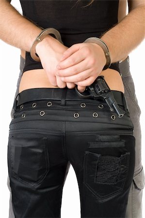 The criminal couple. Handcuffs, pistol. Rear view. Isolated Stock Photo - Budget Royalty-Free & Subscription, Code: 400-05073069