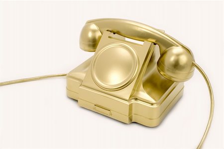 The telephone of gold colour on a white background. Stockbilder - Microstock & Abonnement, Bildnummer: 400-05073352