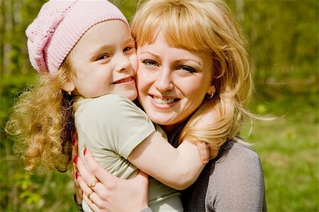 simsearch:400-06389659,k - The beautiful little girl in a pink cap embraces mum with light hair Stock Photo - Budget Royalty-Free & Subscription, Code: 400-05073460
