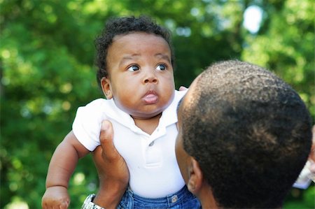 An african american father playing with his infant son Stock Photo - Budget Royalty-Free & Subscription, Code: 400-05073533