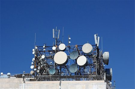 rooftop antenna - A cluster of antennas on top of a telecommunication-agency building Stock Photo - Budget Royalty-Free & Subscription, Code: 400-05073997