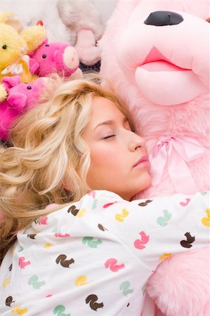 simsearch:400-04316737,k - A girl lying on bed, hugging a teddy bear - part of a series. Stock Photo - Budget Royalty-Free & Subscription, Code: 400-05084753
