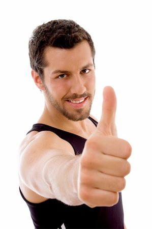 young male with thumbs up on an isolated white background Stock Photo - Budget Royalty-Free & Subscription, Code: 400-05084996